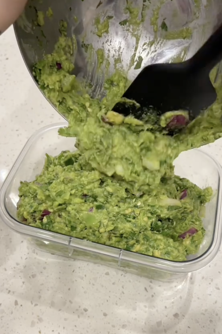 guacamole being put into a container