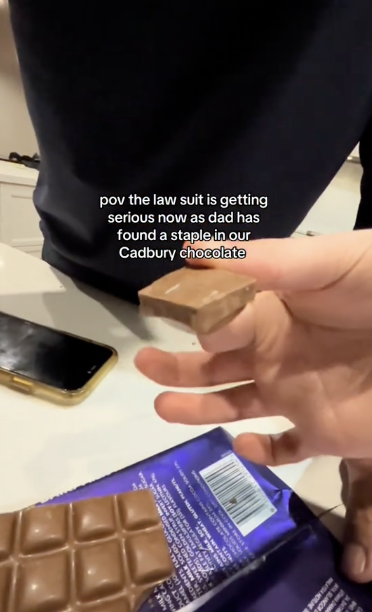 woman holding a piece of chocolate