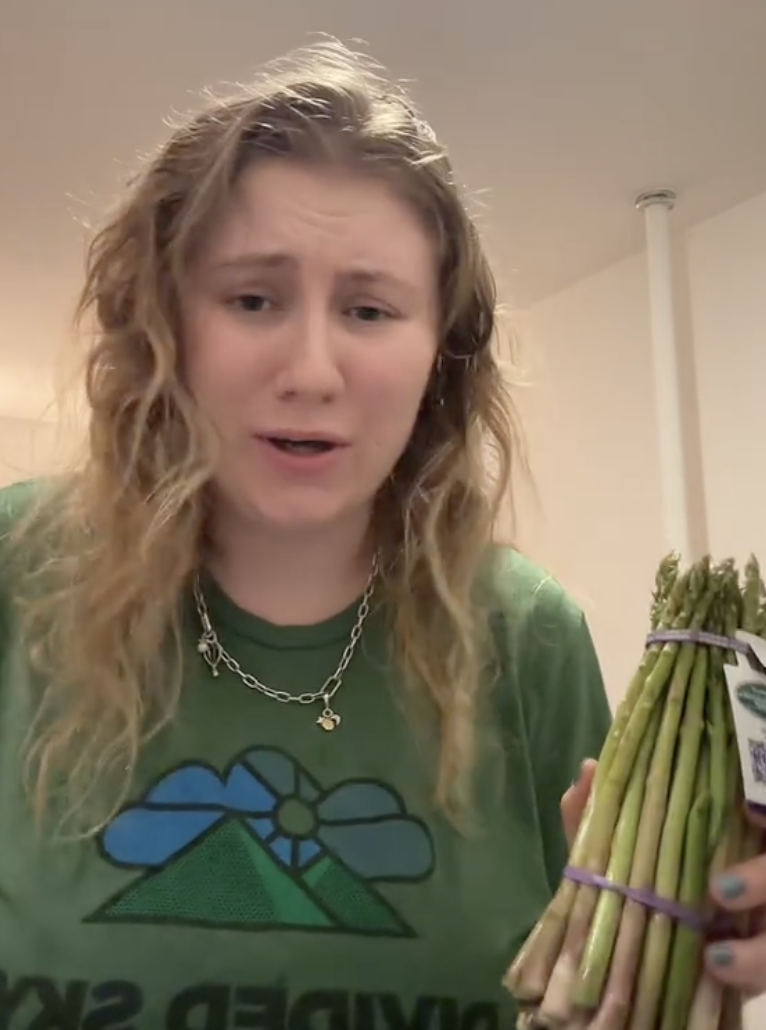 woman holding some asparagus