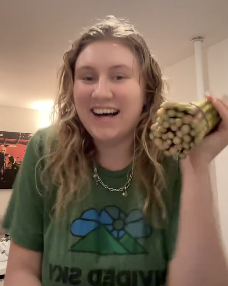 woman holding a bunch of asparagus