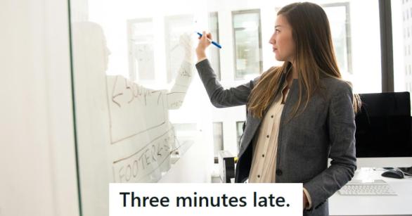 Smug woman writing on a whiteboard after winning her discussion