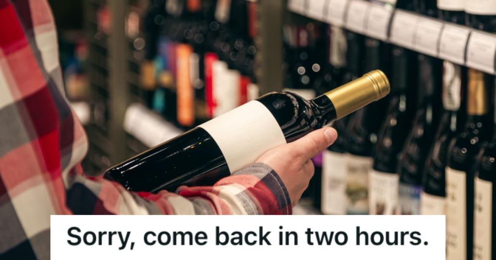 Man holding a bottle of wine in a liquor store