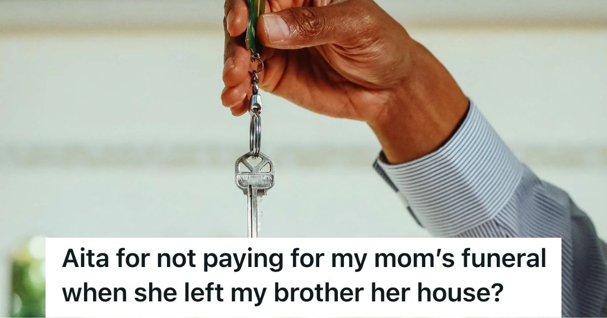 Man's hand holding up a house key