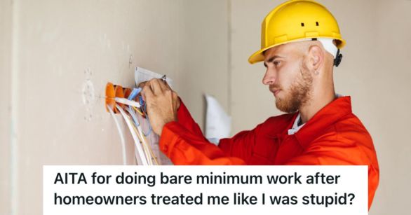 Electrician in uniform and hard hat fixing an electrical outlet