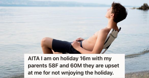 Teenage boy sun bathing while sitting on a beach chair