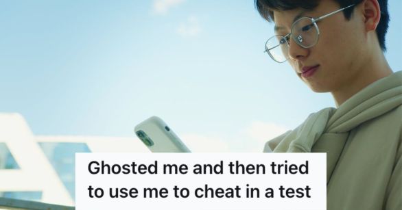 Male student with glasses looking at his phone