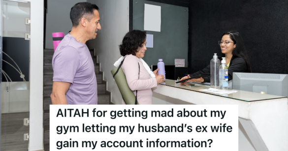 older couple with yoga mats at the front desk of a gym