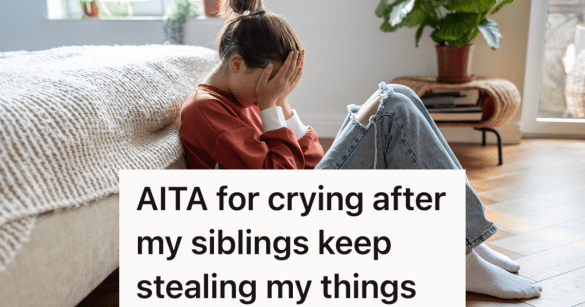 upset teen girl sitting on the floor next to her bed covering her face with her hands