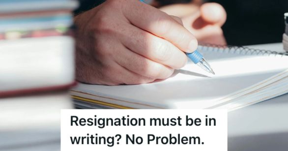 Person's hand holding a pen and writing on a notebook