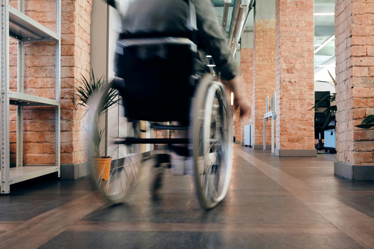 A wheelchair user in an office