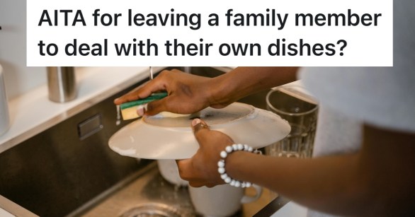 person washing a dish in the sink by hand