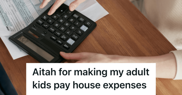 person using a calculator on a wooden desk