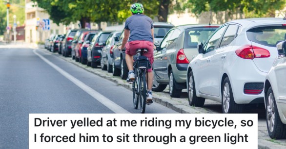 man riding bicycle down street