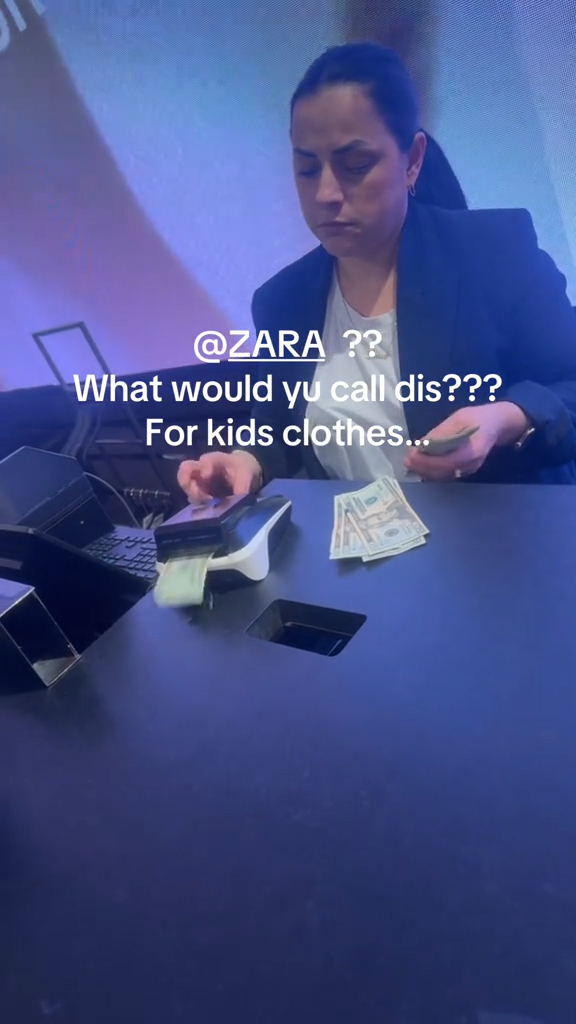 A cashier scanning bills at checkout