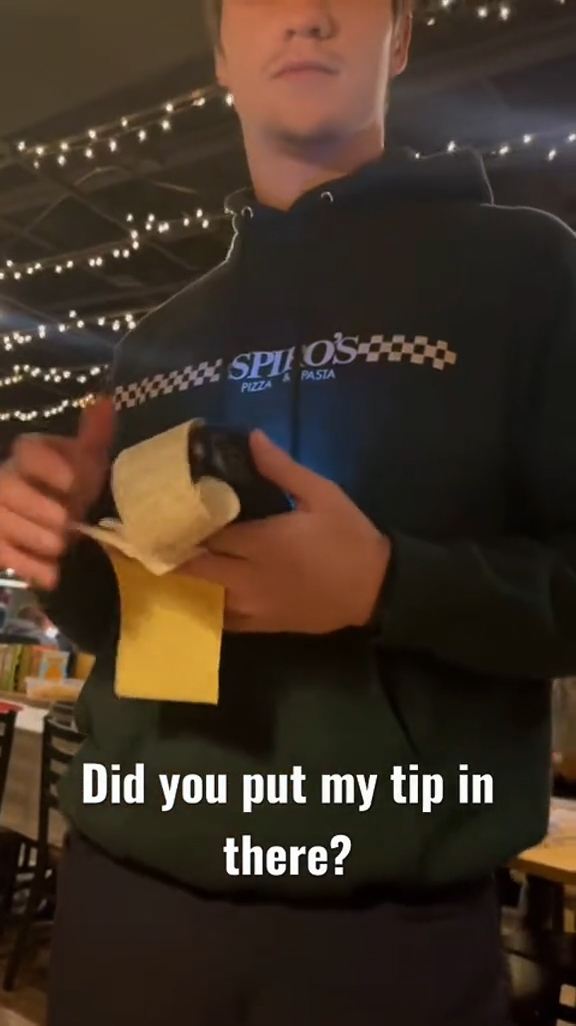 A couple talking to their waiter at a restaurant