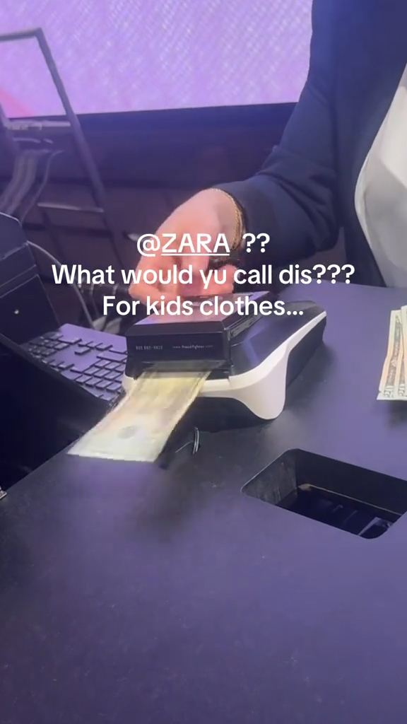 A cashier scanning bills at checkout