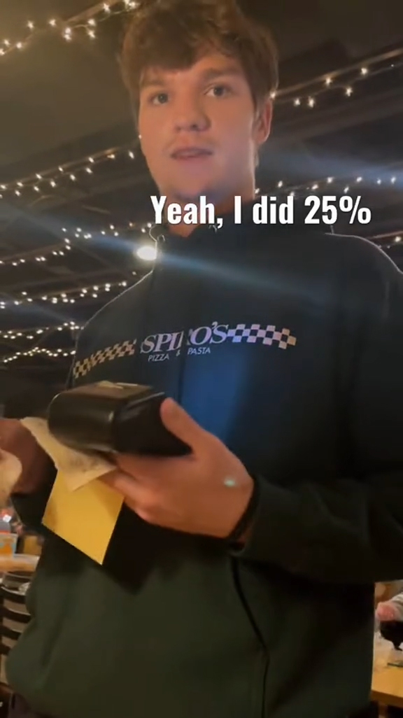 A couple talking to their waiter at a restaurant