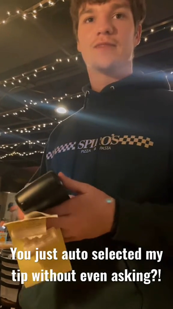 A couple talking to their waiter at a restaurant