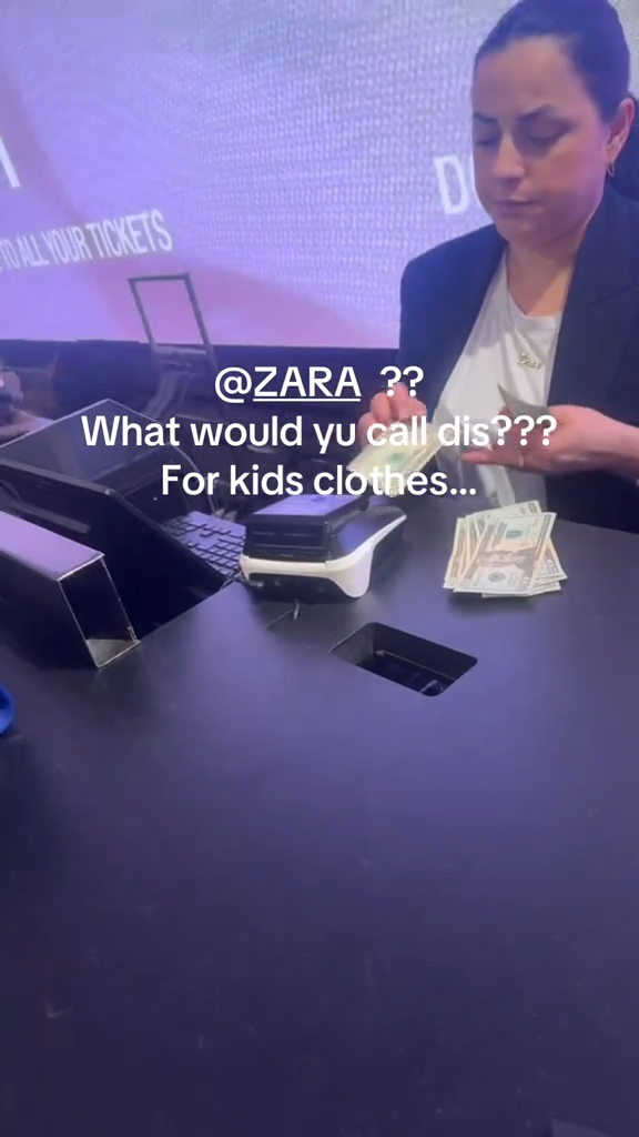 A cashier scanning bills at checkout