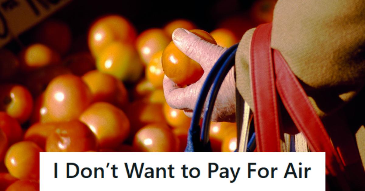 Woman buying tomatoes at the grocery store