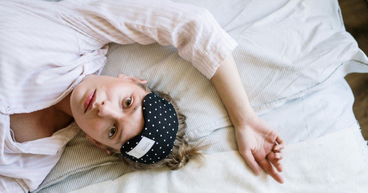 An awake woman with a sleep mask