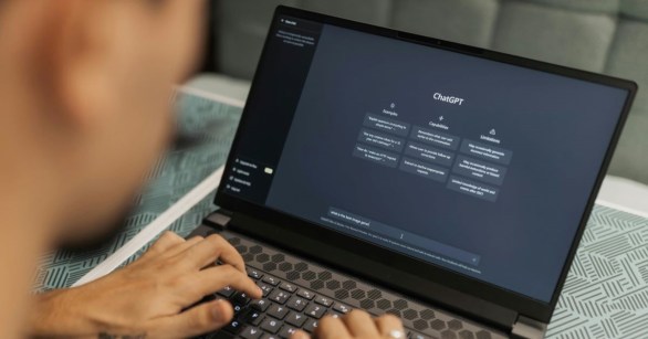 A man on a laptop using ChatGPT