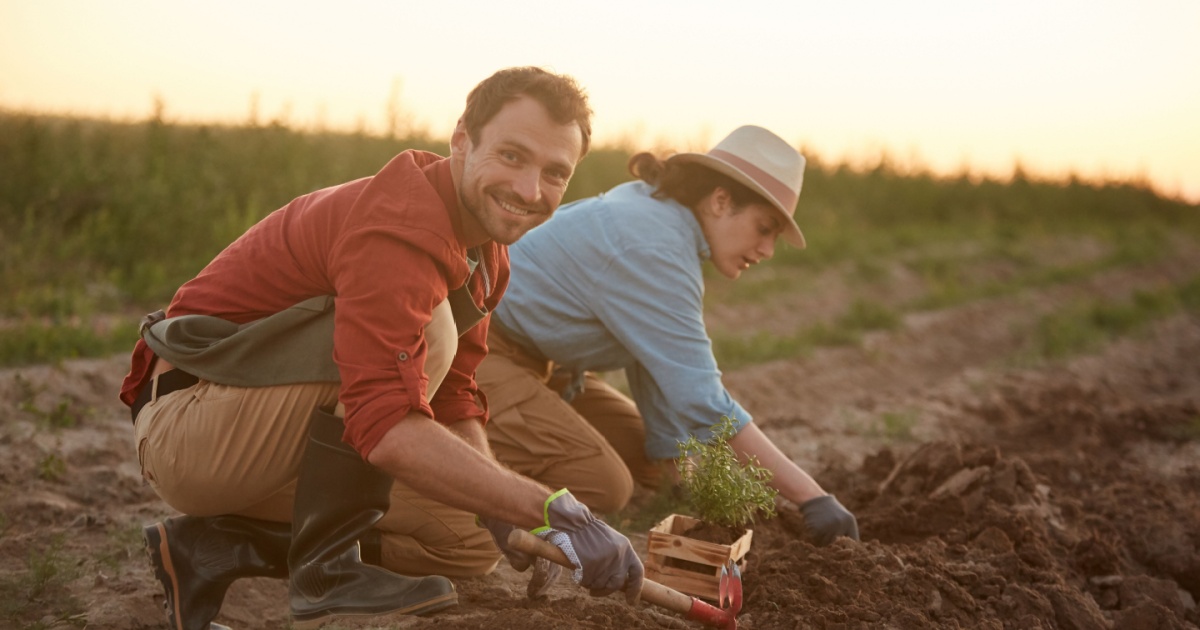 Man and woman digging in dirt