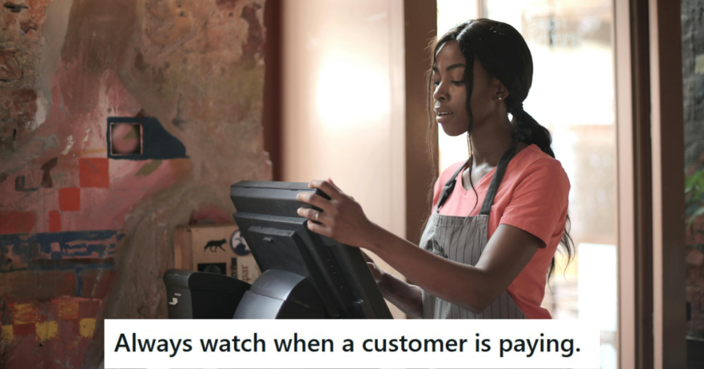 Woman in apron standing at a cashier