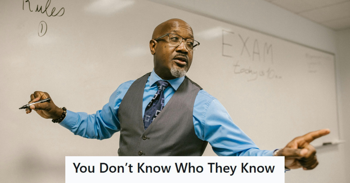 Man in suit teaching a class