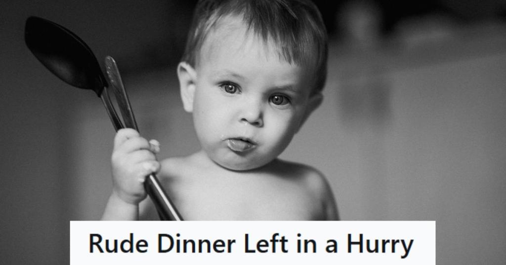 Black and white photo of a baby holding spoons in his hand
