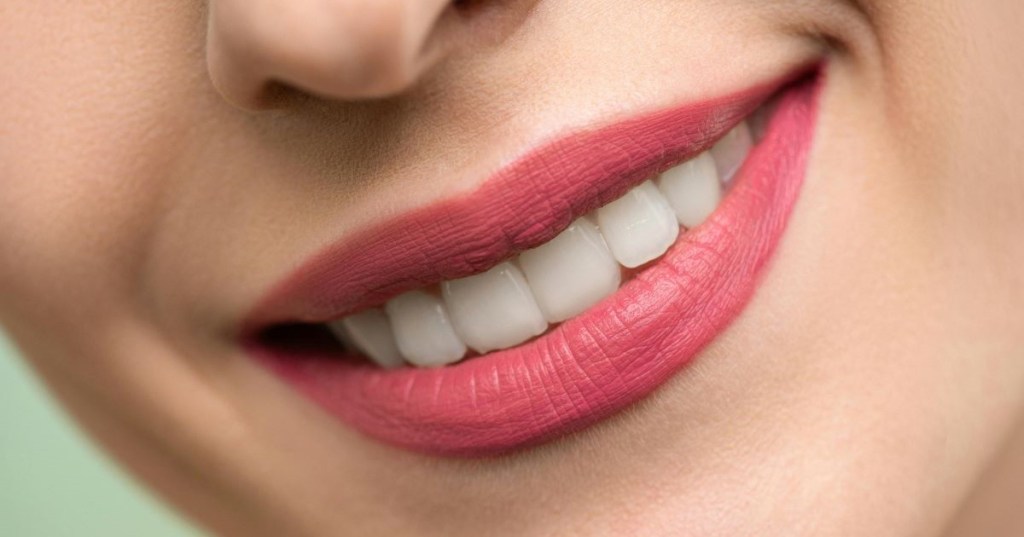 Smile with teeth and pink lipstick