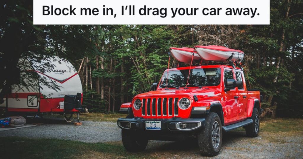 A Red 4WD truck carrying 2 kayaks on the roof parked on a camping site