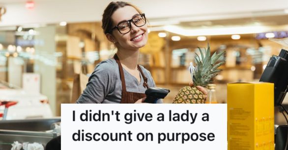 Female cashier happily ringing up items in the supermarket