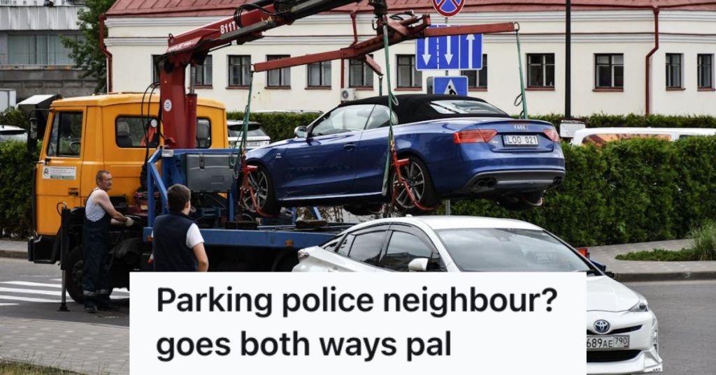 Towing truck lifting a car from the street with another one parked near the sidewalk
