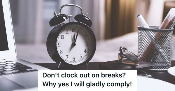 A clock on a worker's desk with their laptop and pen holder