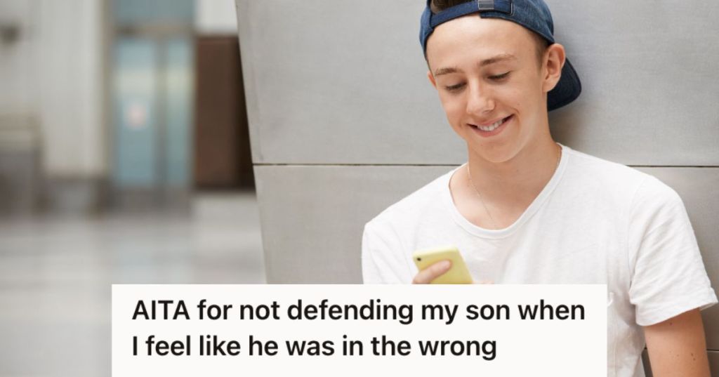 Teenage boy looking at his phone and smiling