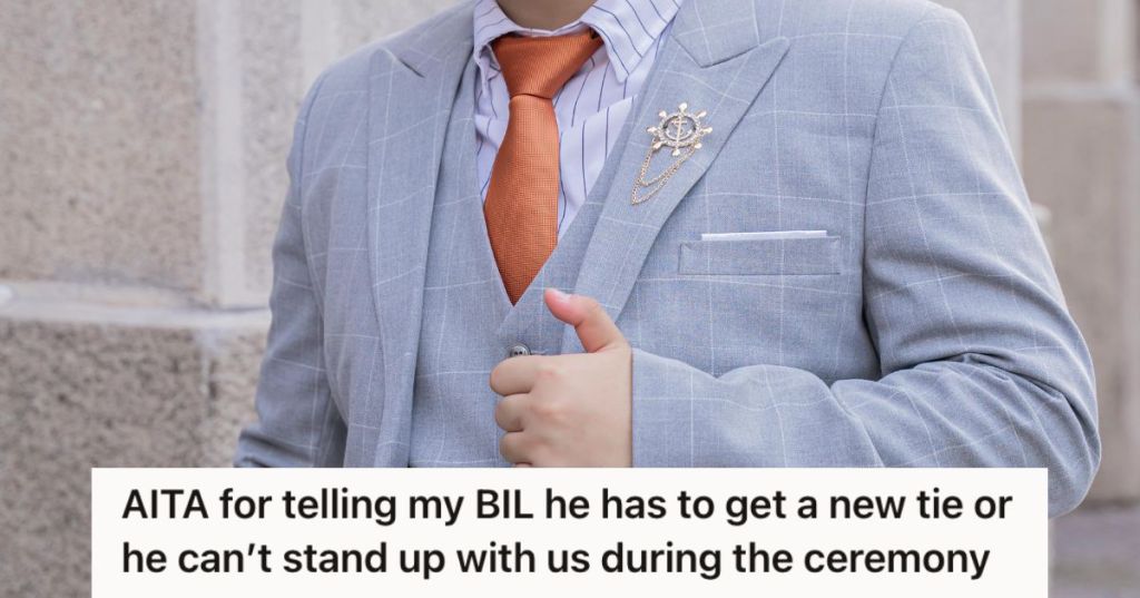 Man wearing a suit and an orange tie