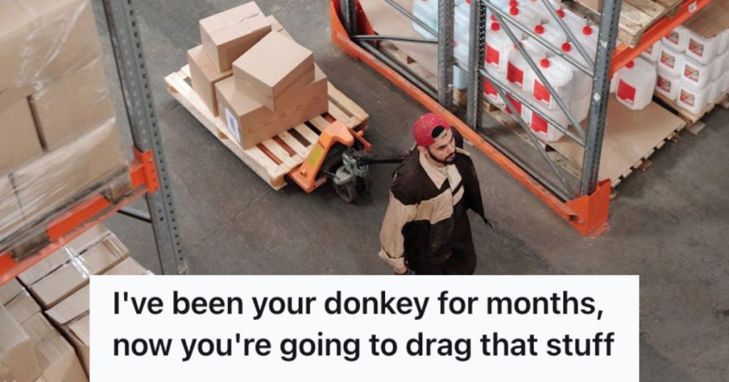 Male worker pulling a cart with boxes on top of it