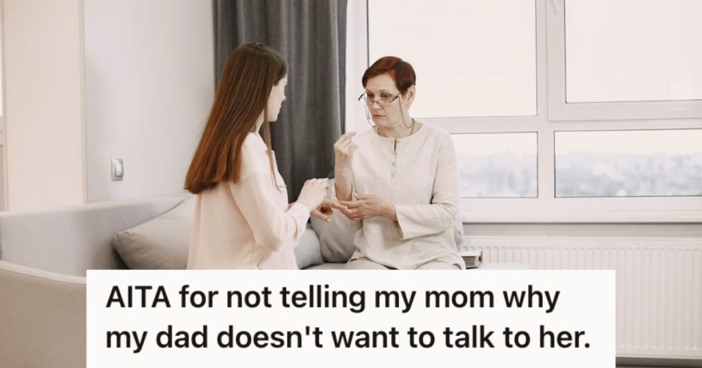 Two women in white talking while sitting on teh couch