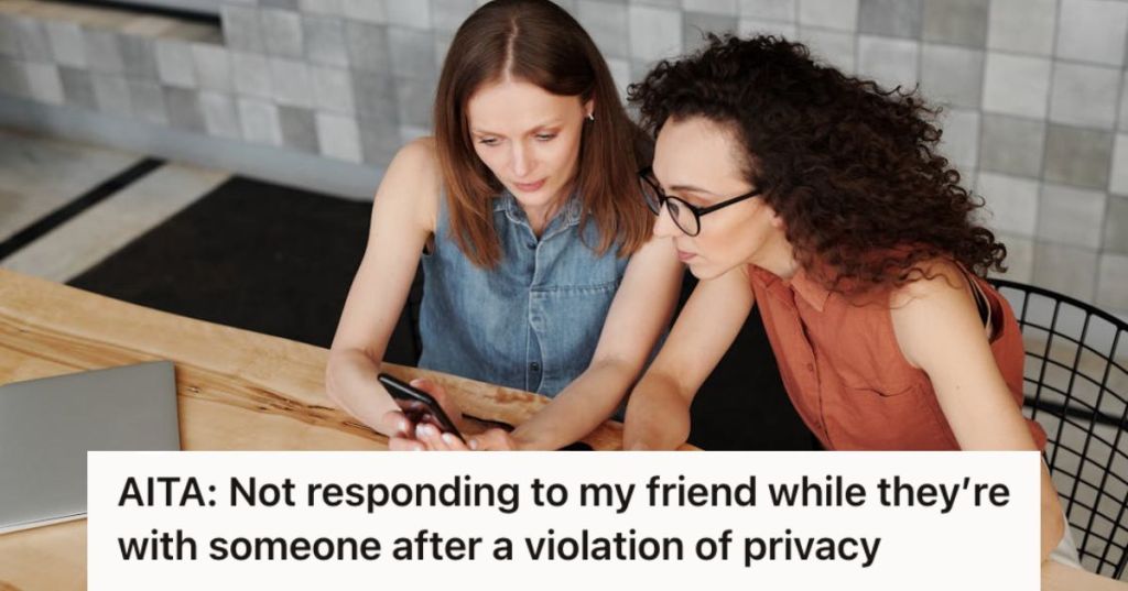 Two women looking at a phone intently