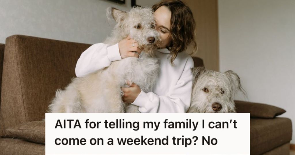 Woman cuddling and kissing her dogs