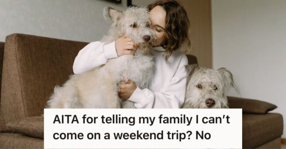 Woman cuddling and kissing her dogs