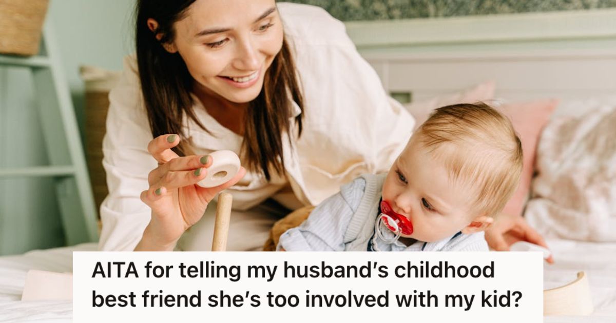 Woman playing with baby boy on the bed