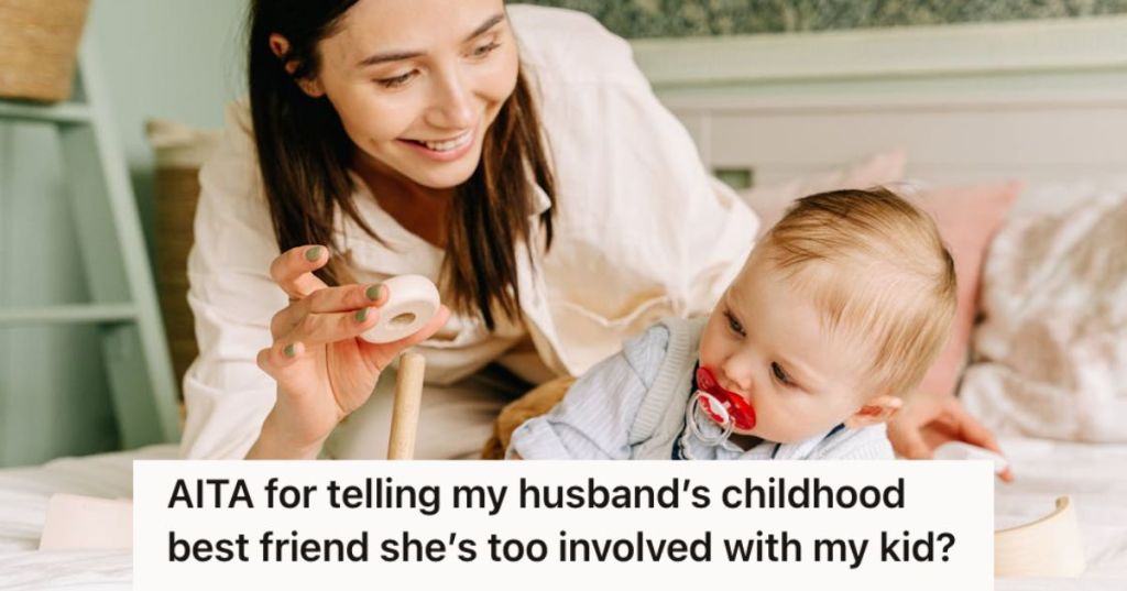 Woman playing with baby boy on the bed