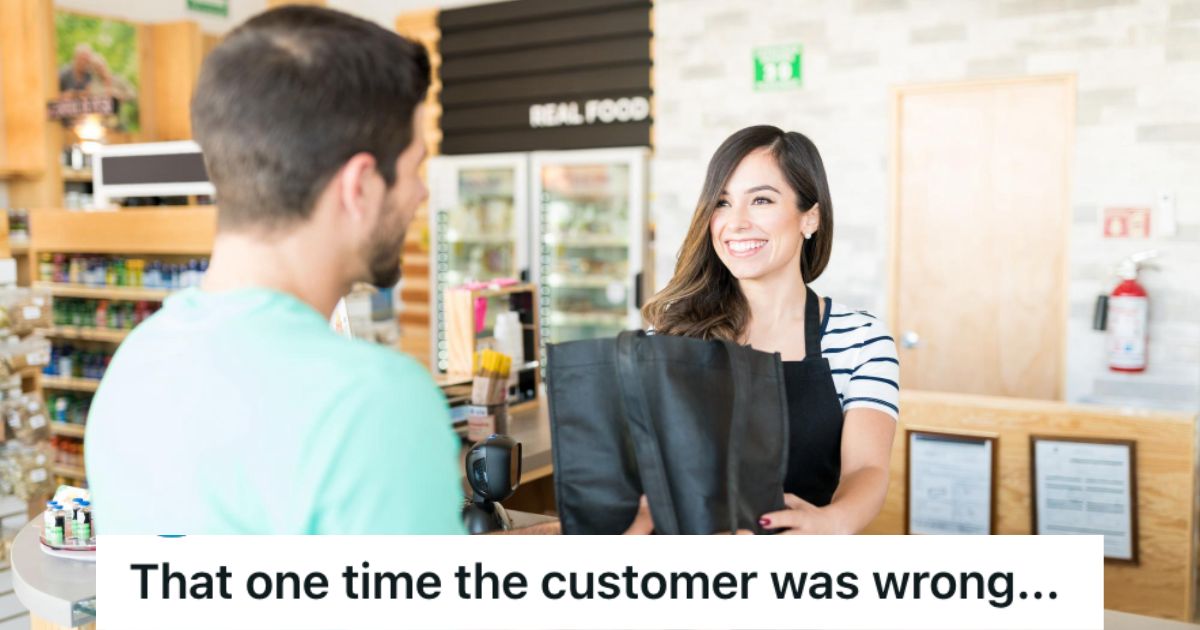 Retail employee smiling at the customer while handing him black shopping bags