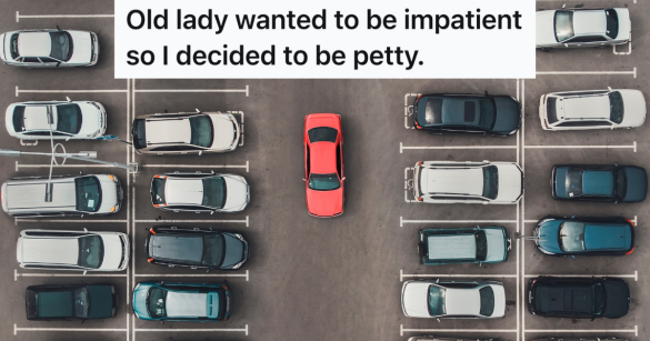 red car driving in a crowded parking lot