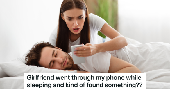 woman looking at man's phone while he sleeps