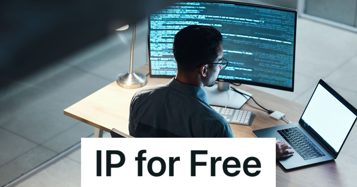 man looking at code on a monitor