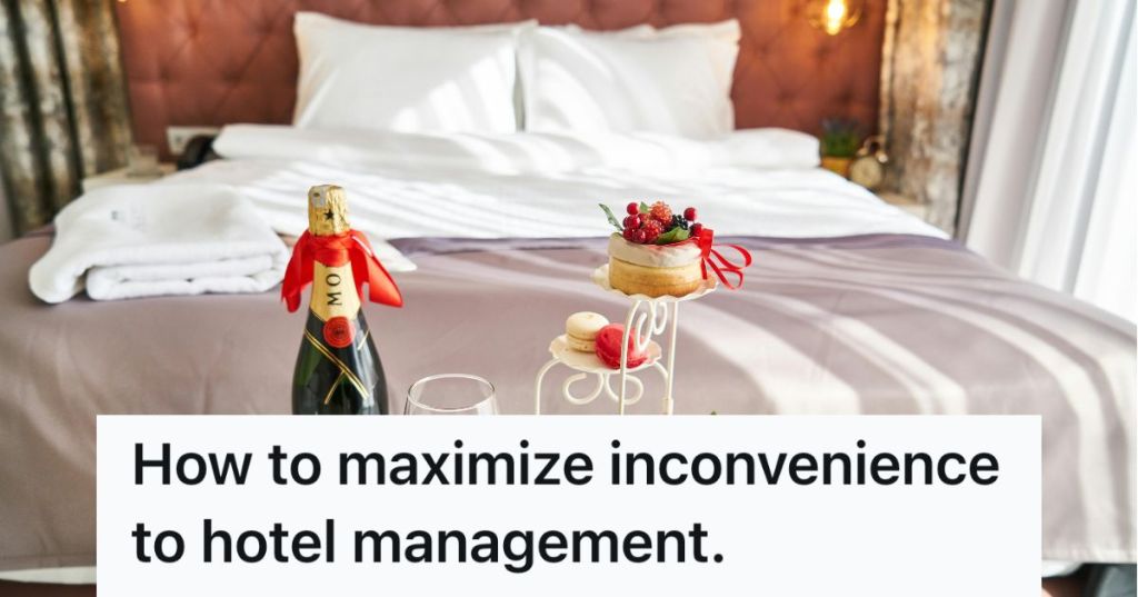 A hotel bed with champagne and treats in front