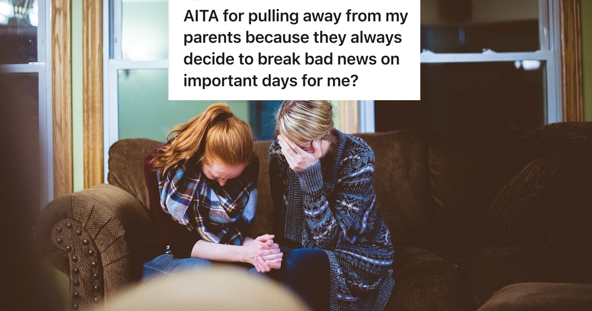two sad women looking down and holding hands